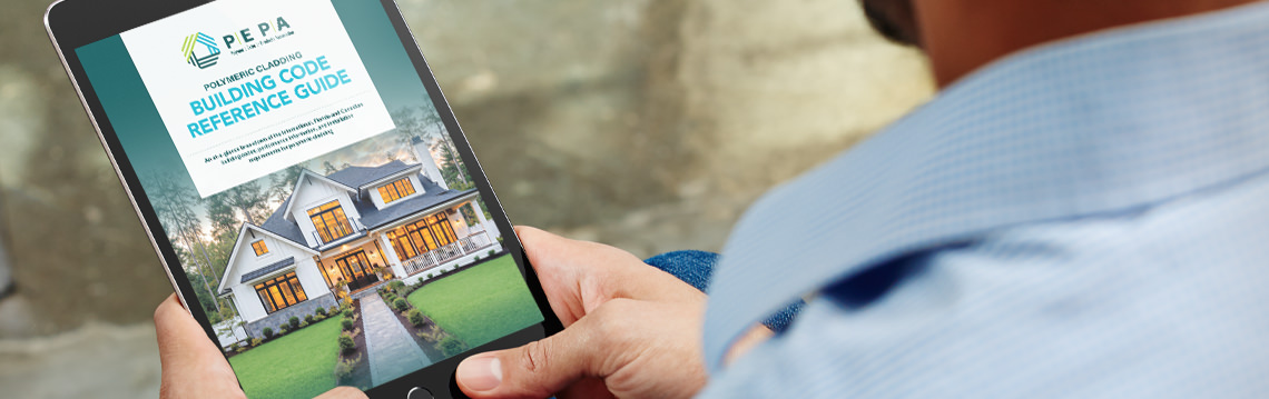 Man holding tablet with VSI Building Code Reference Guide displayed